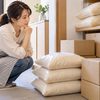 定期便で届くお米の保管場所を考え、米袋と配送箱を確認する女性