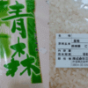 青森県産まっしぐらの米袋と、熊本県産にじのきらめきの産地・品種・産年が記載された精米表示ラベル